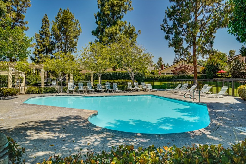 49 East Yale Loop, Unit 26 Irvine, CA 92604 - Photo 60 of 63 a view of a swimming pool with a lake view