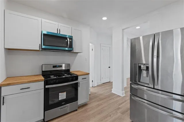 a kitchen with stainless steel appliances a stove microwave and a refrigerator