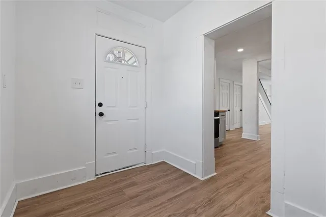 a view of a hallway with wooden floor
