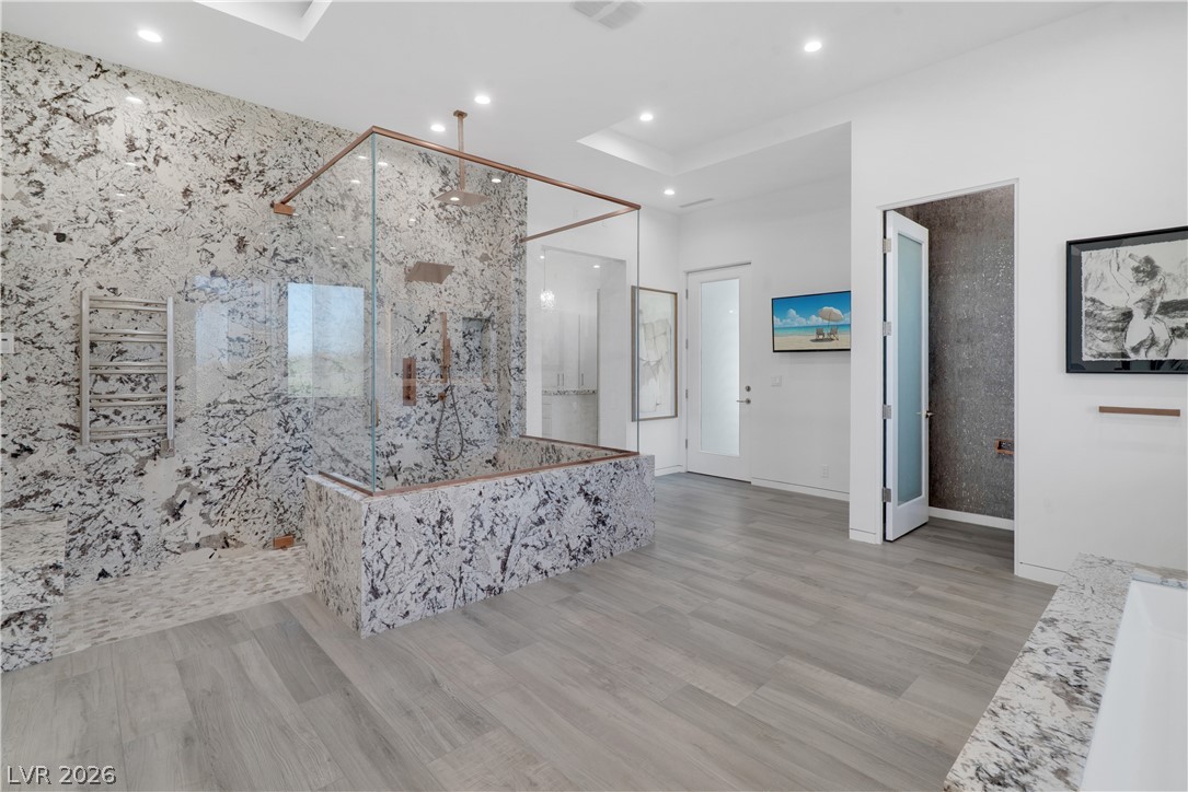 10 Ridge Blossom Road Las Vegas, NV 89135 - Photo 22 of 64 Bathroom featuring a marble finish shower, wood finished floors, and recessed lighting