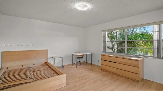 a bedroom with a bed and a chair