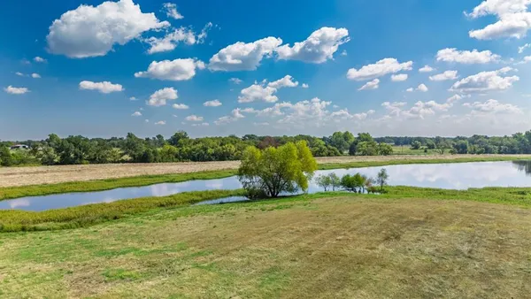 a view of a lake with houses in the background