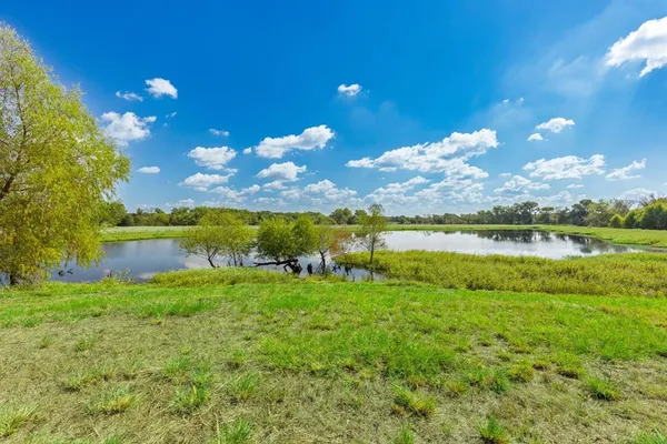a view of a lake with houses in the back