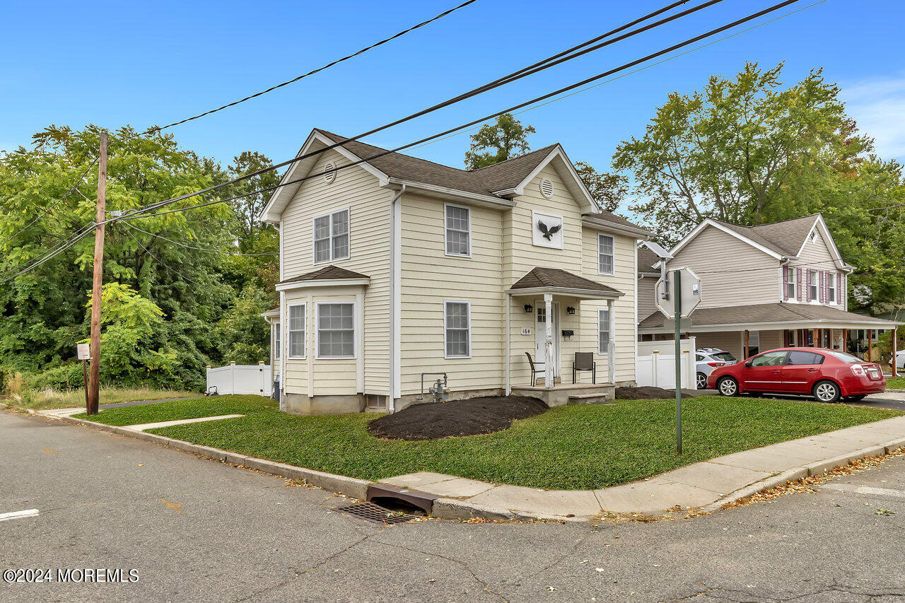 164 Jackson Street Matawan, NJ 07747 - Photo 2 of 26 a front view of a house with a yard and garage