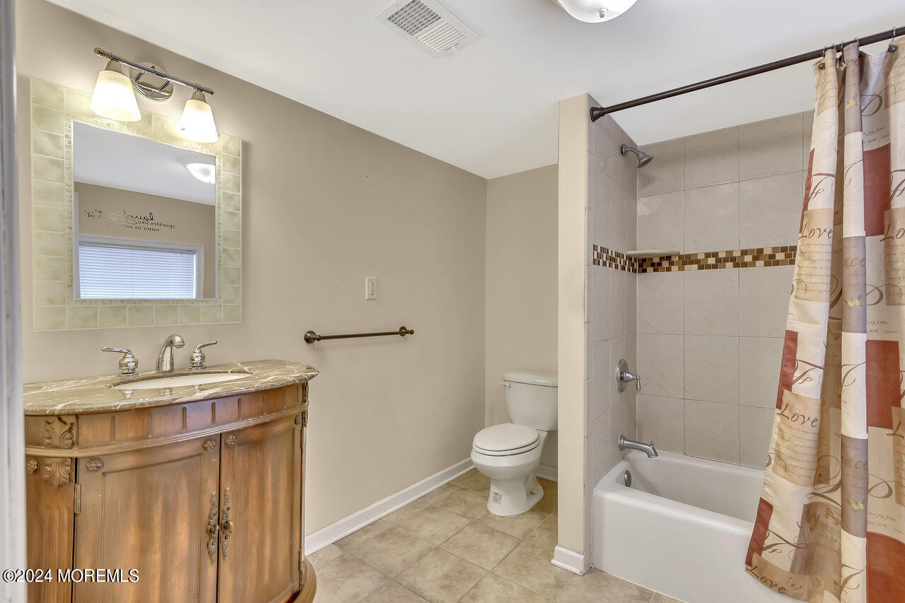 164 Jackson Street Matawan, NJ 07747 - Photo 22 of 26 a bathroom with a bathtub shower sink vanity and toilet