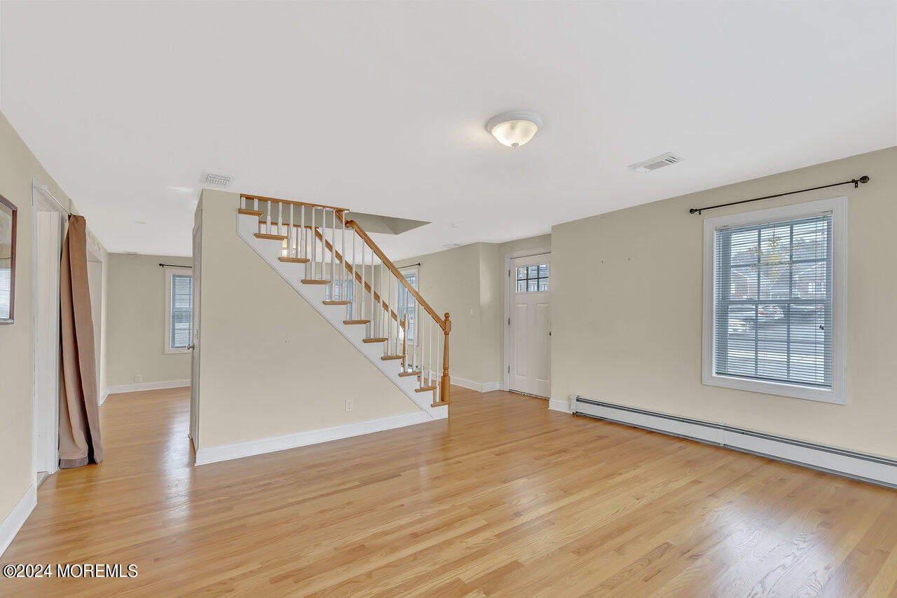 164 Jackson Street Matawan, NJ 07747 - Photo 4 of 26 a view of an empty room with wooden floor and a window