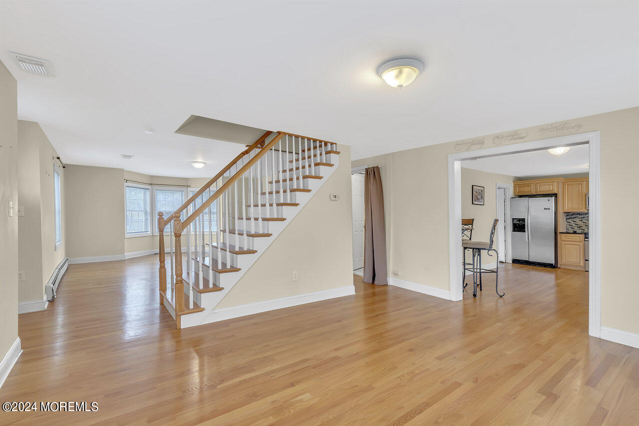 164 Jackson Street Matawan, NJ 07747 - Photo 8 of 26 a view of a hallway with wooden floor and staircase