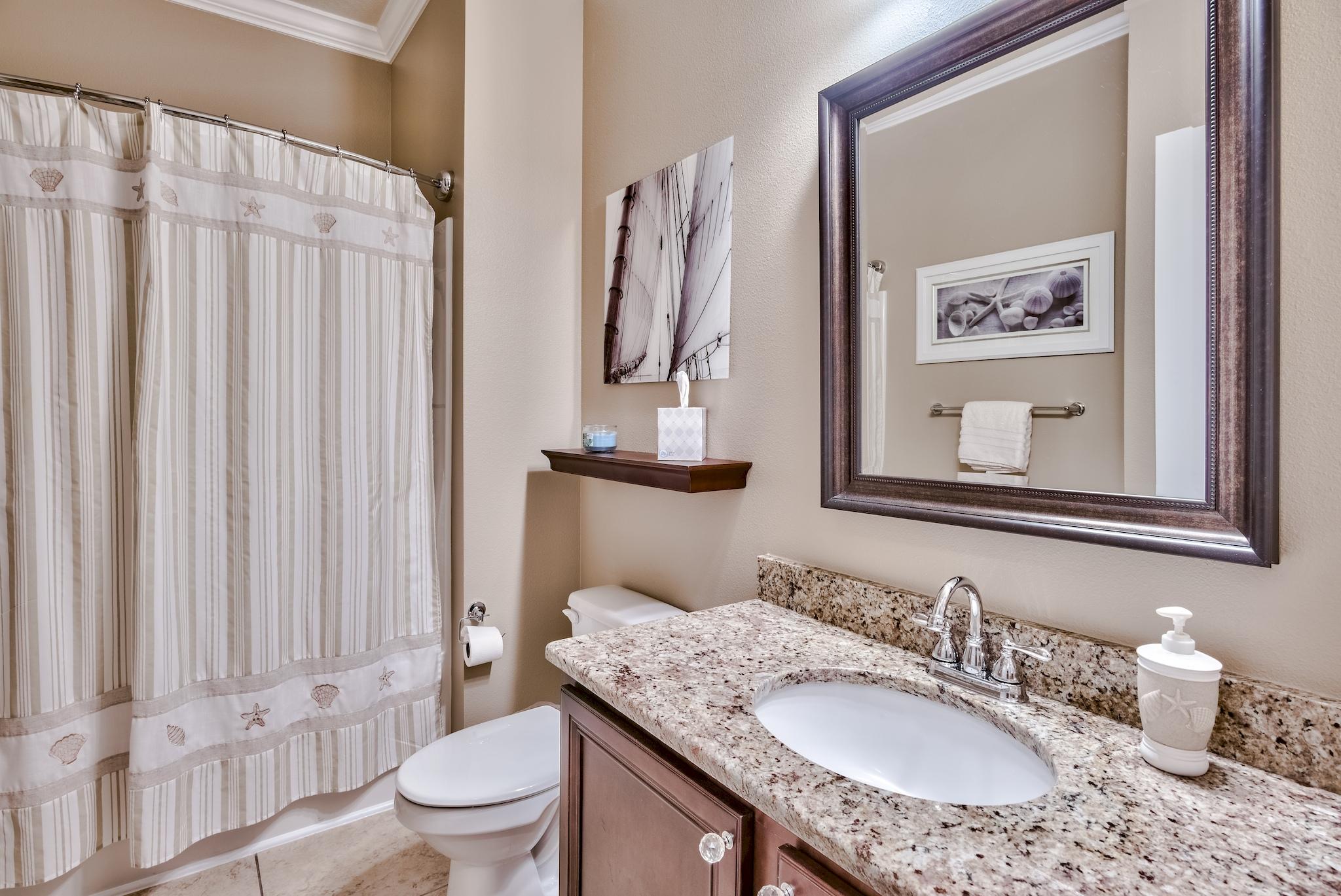 464 Pin Oak Loop Santa Rosa Beach, FL 32459 - Photo 33 of 44 a bathroom with a granite countertop sink a toilet and a mirror