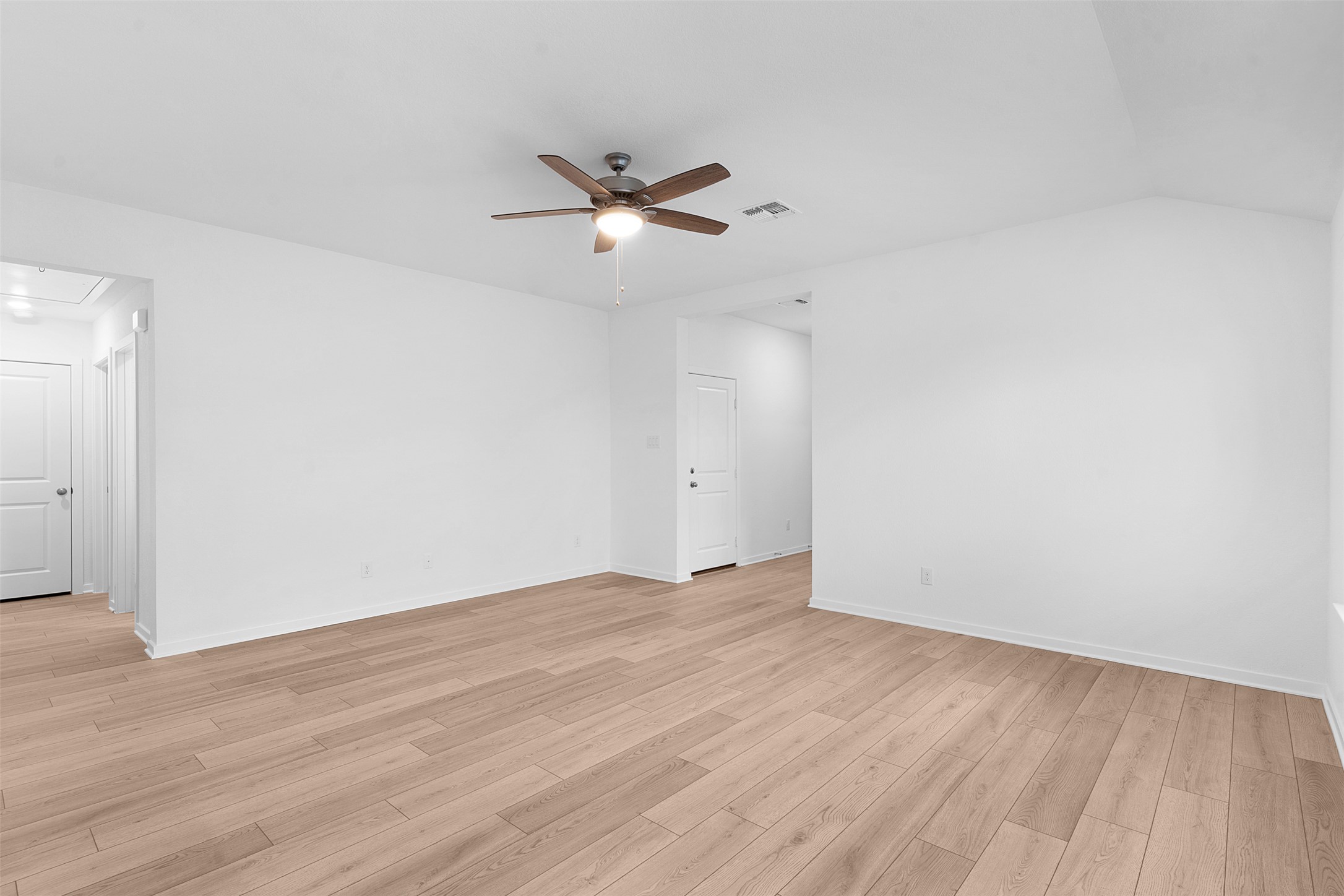 13721 Tucker Hedge Pass Elgin, TX 78621 - Photo 6 of 28 Empty room with attic access, light wood-style flooring, ceiling fan, and lofted ceiling