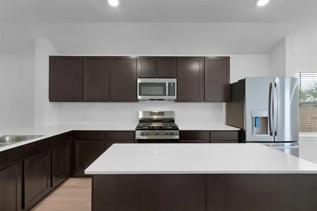 a kitchen with a sink and a refrigerator