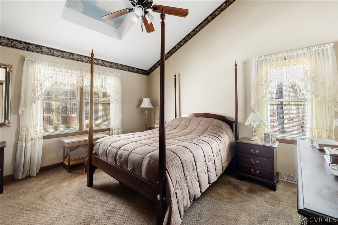 9221 Cattail Road Chesterfield, VA 23838 - Photo 18 of 34 a bedroom with a bed window and a chandelier