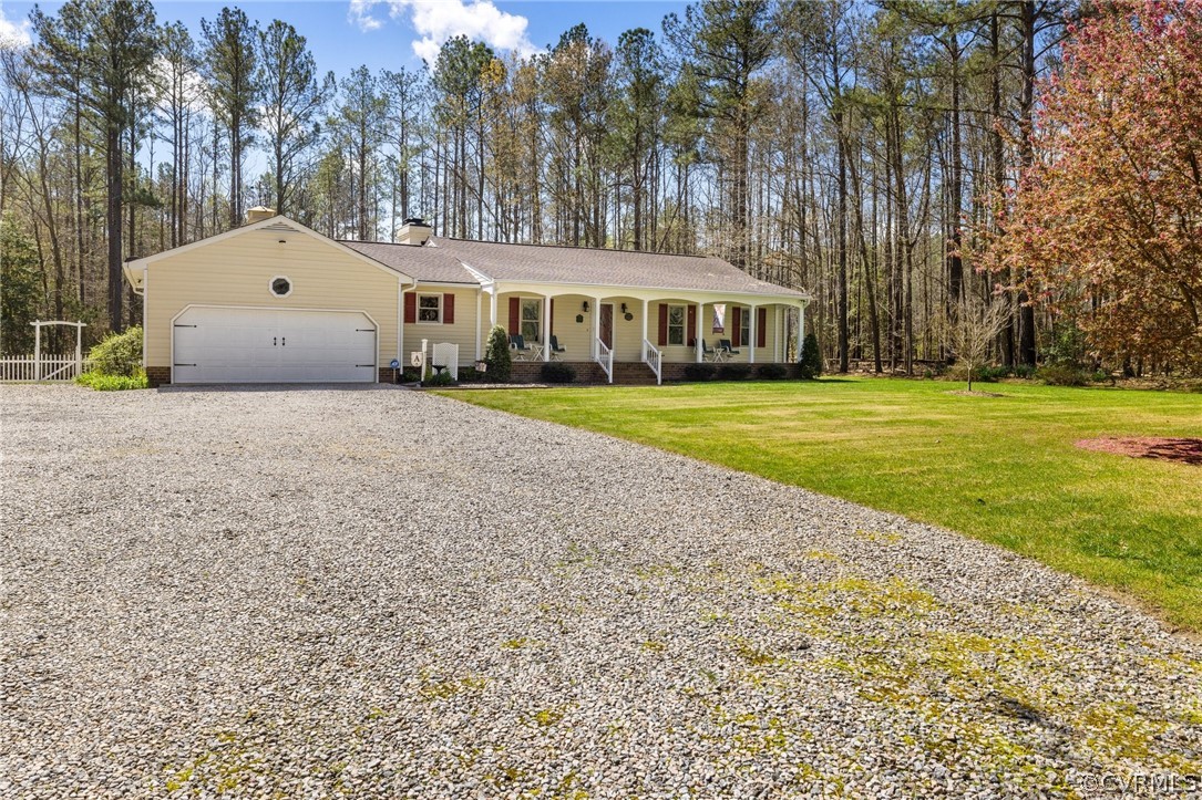 9221 Cattail Road Chesterfield, VA 23838 - Photo 3 of 34 a front view of a house with a garden and trees