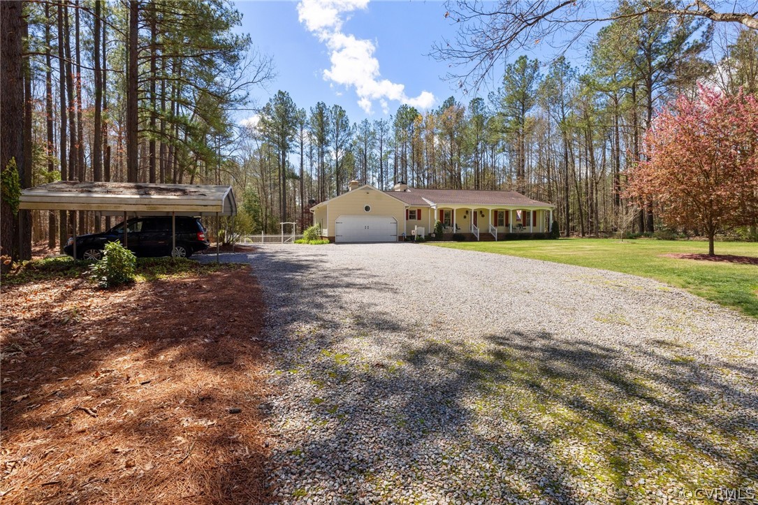 9221 Cattail Road Chesterfield, VA 23838 - Photo 4 of 34 a front view of a house with a yard and garage