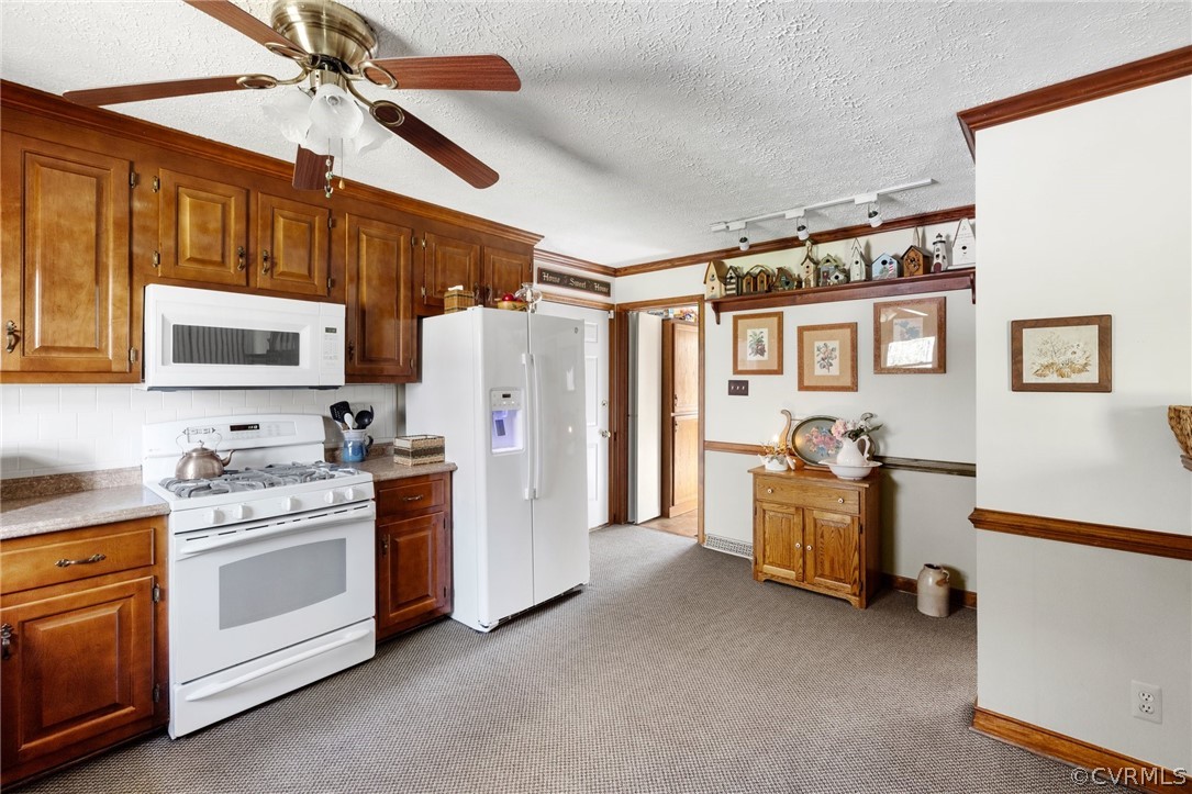 9221 Cattail Road Chesterfield, VA 23838 - Photo 10 of 34 a kitchen with stainless steel appliances a stove a refrigerator cabinets dining table and chairs