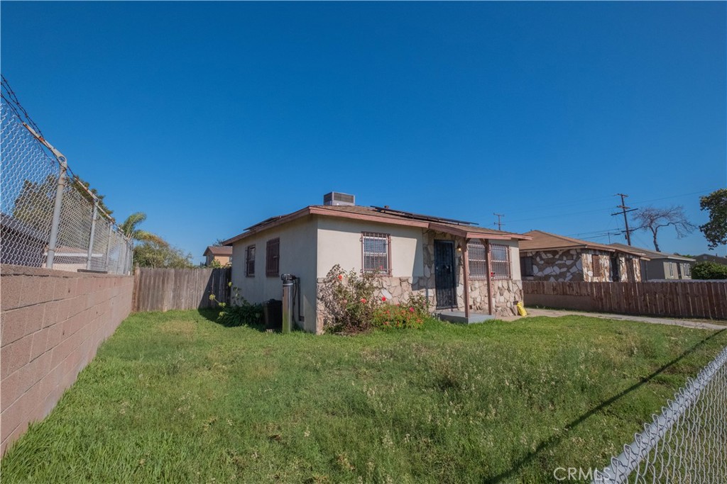 a view of a house with a yard and sitting area
