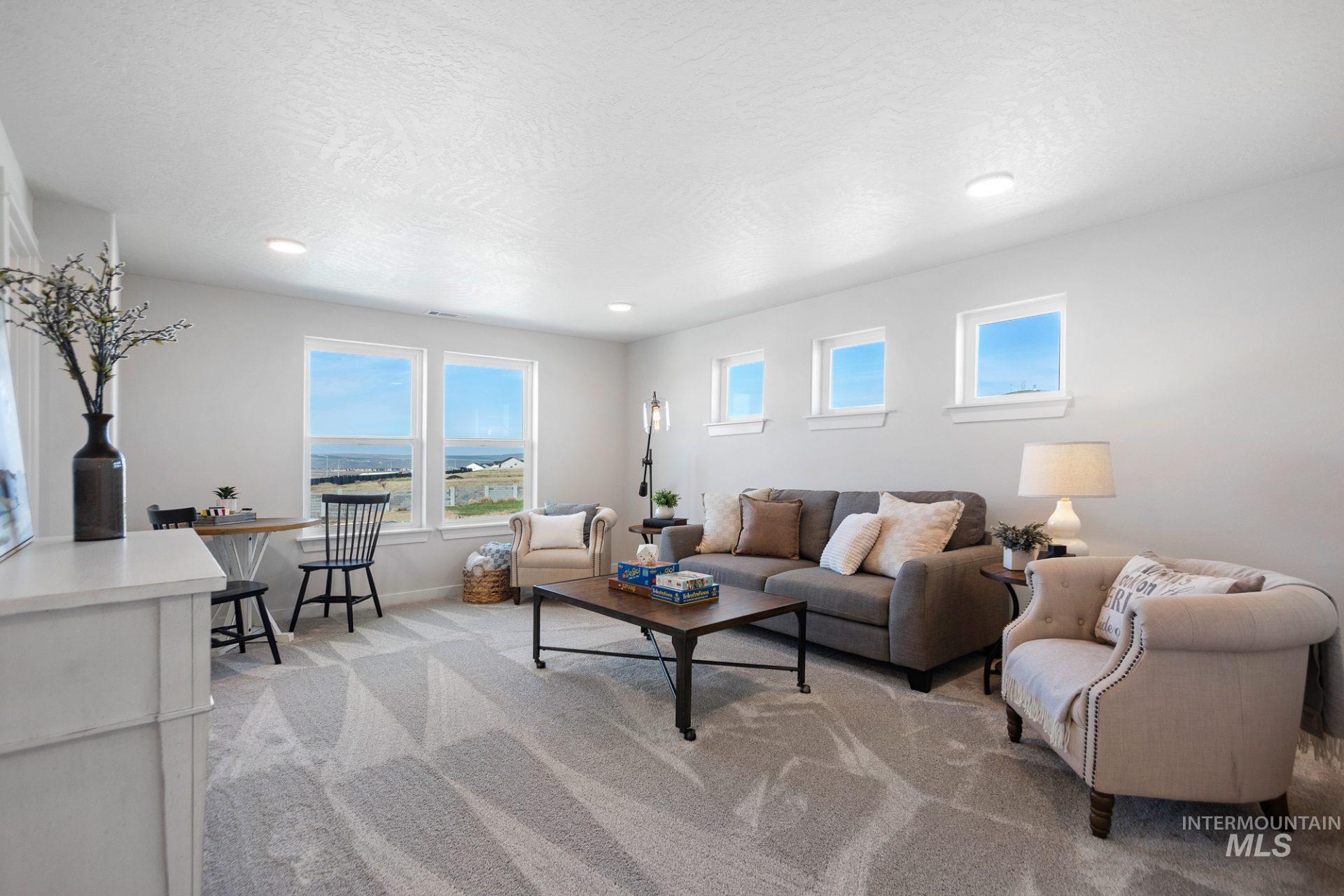 802 Coral Road Kimberly, ID 83341 - Photo 14 of 29 Living room with light colored carpet, healthy amount of natural light, a textured ceiling, and recessed lighting