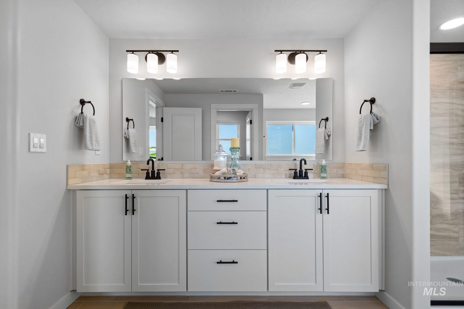 802 Coral Road Kimberly, ID 83341 - Photo 19 of 29 Full bathroom with double vanity, a stall shower, and backsplash