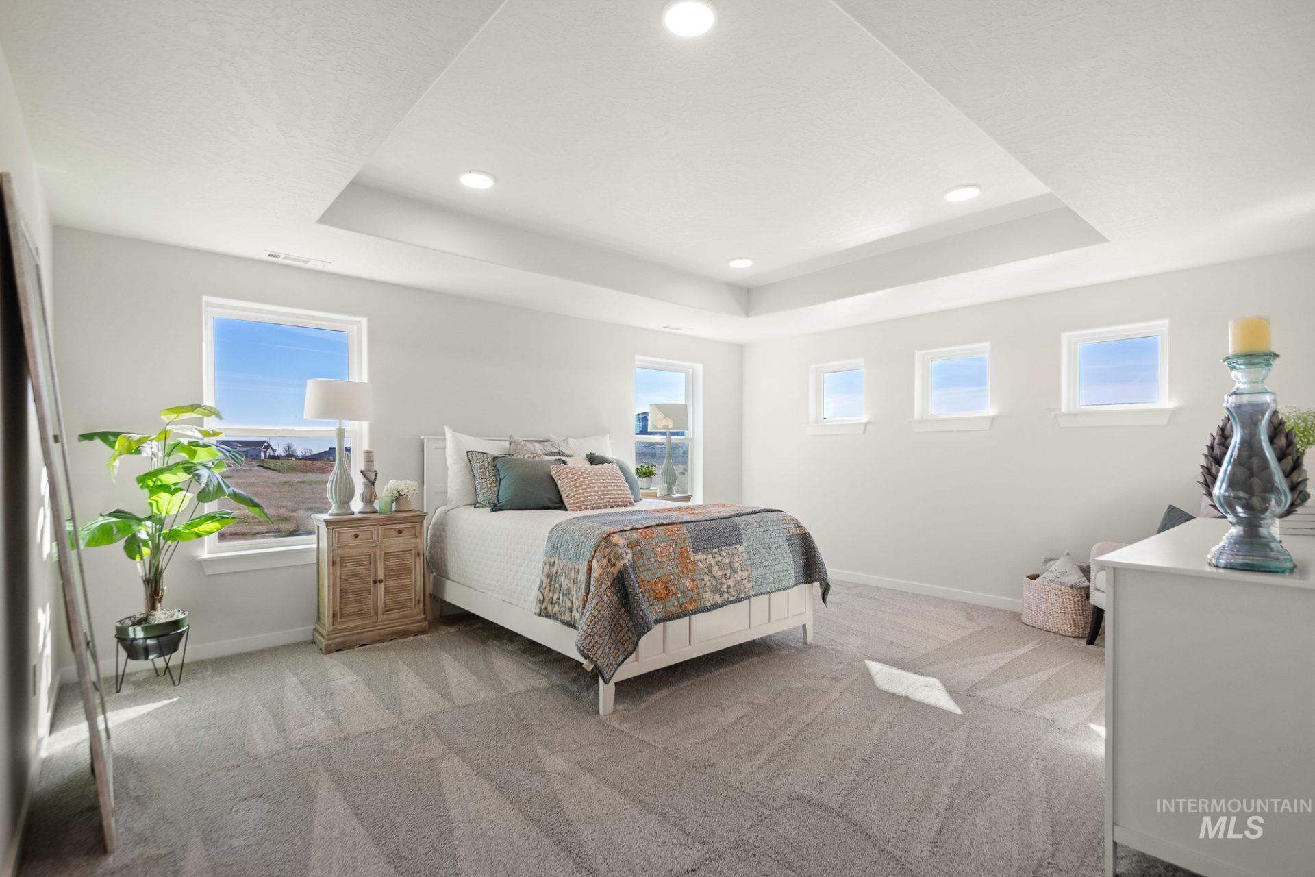802 Coral Road Kimberly, ID 83341 - Photo 21 of 29 Bedroom featuring light carpet, a raised ceiling, and recessed lighting