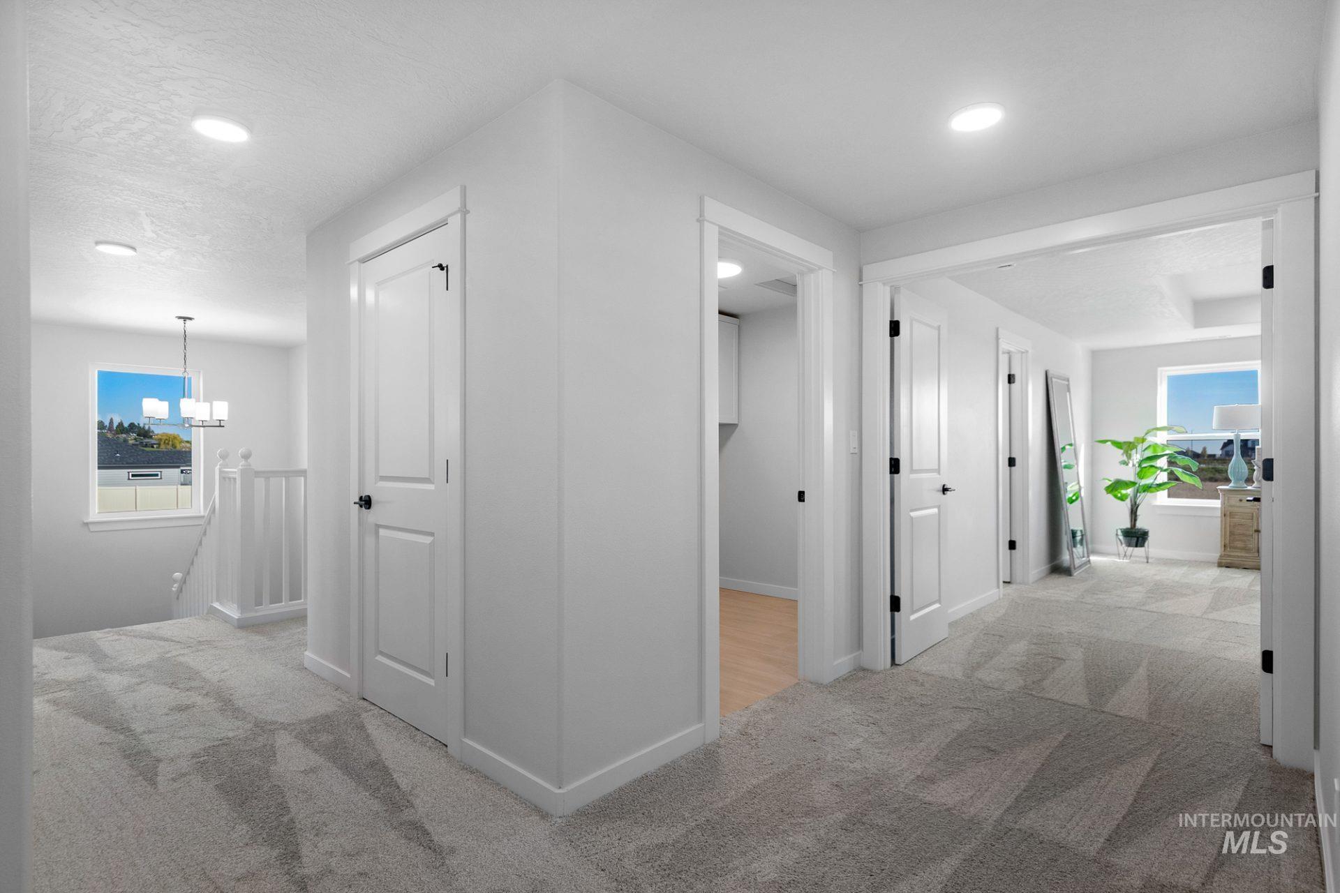 802 Coral Road Kimberly, ID 83341 - Photo 22 of 29 Hallway featuring plenty of natural light, light carpet, an upstairs landing, and recessed lighting
