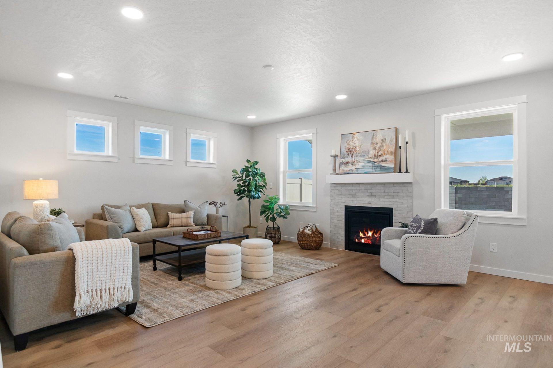 802 Coral Road Kimberly, ID 83341 - Photo 26 of 29 Living room with a brick fireplace, light wood-style flooring, healthy amount of natural light, and recessed lighting