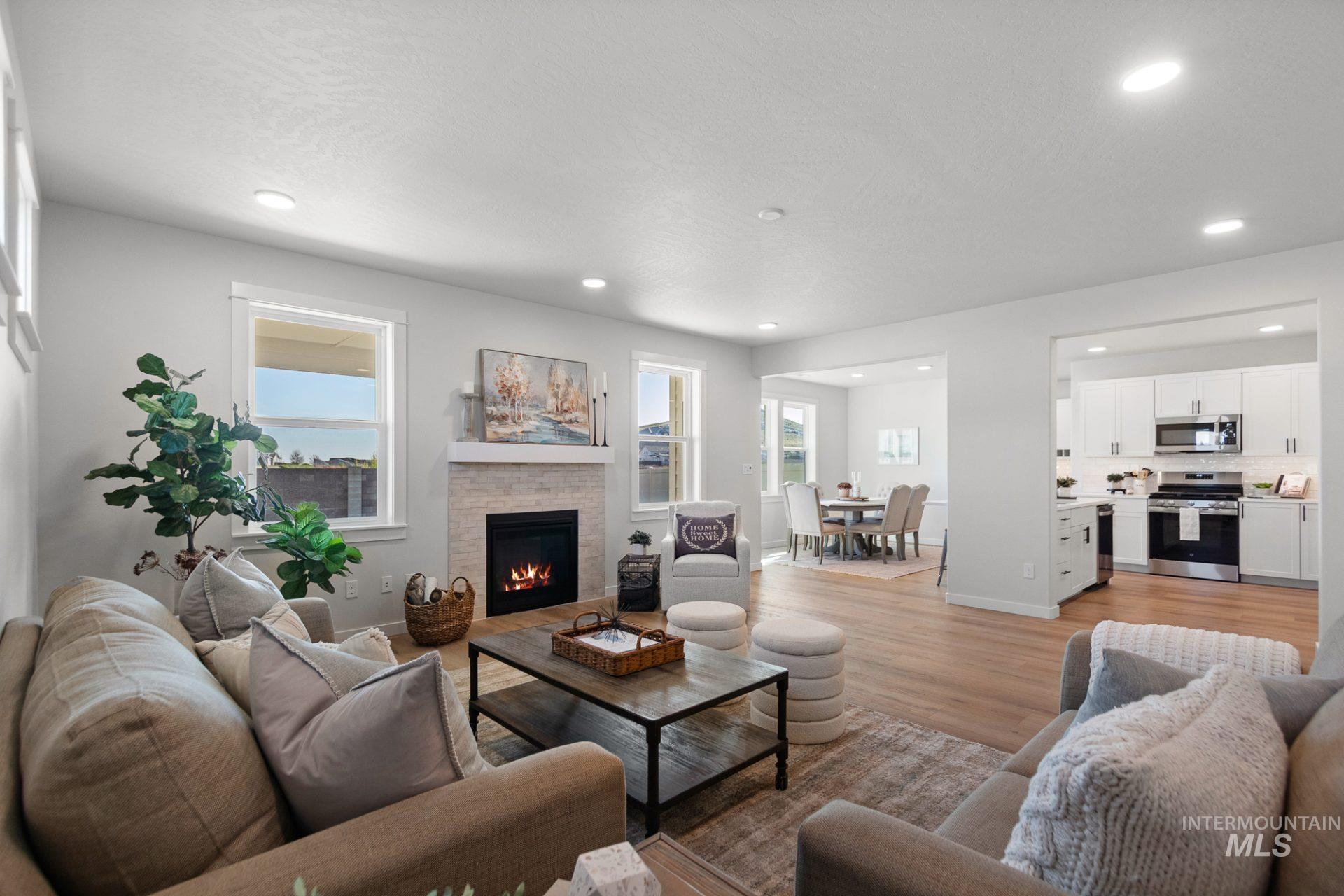 802 Coral Road Kimberly, ID 83341 - Photo 27 of 29 Living area with a warm lit fireplace, light wood-type flooring, healthy amount of natural light, and recessed lighting