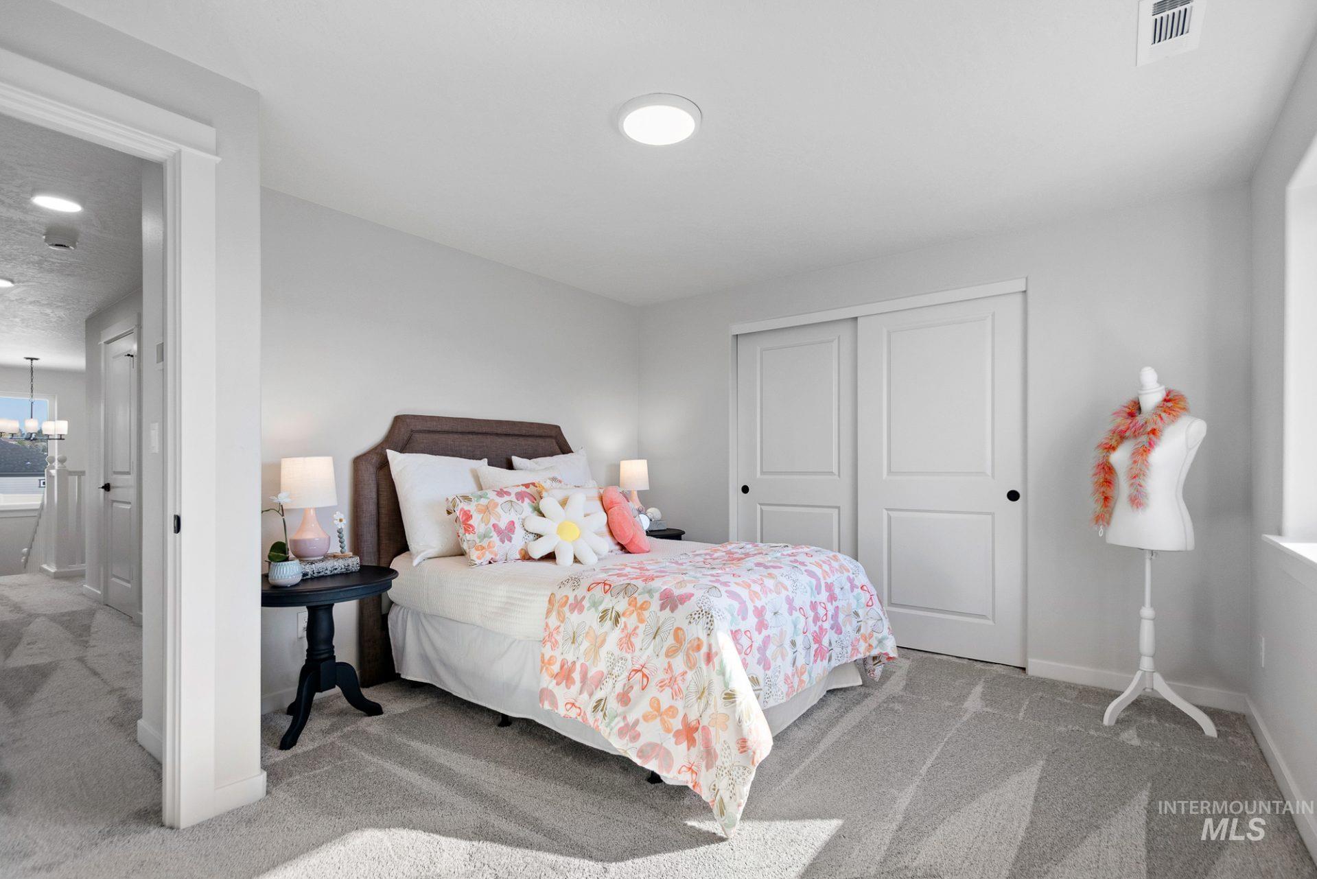 802 Coral Road Kimberly, ID 83341 - Photo 7 of 29 Bedroom featuring light carpet, a closet, and a chandelier