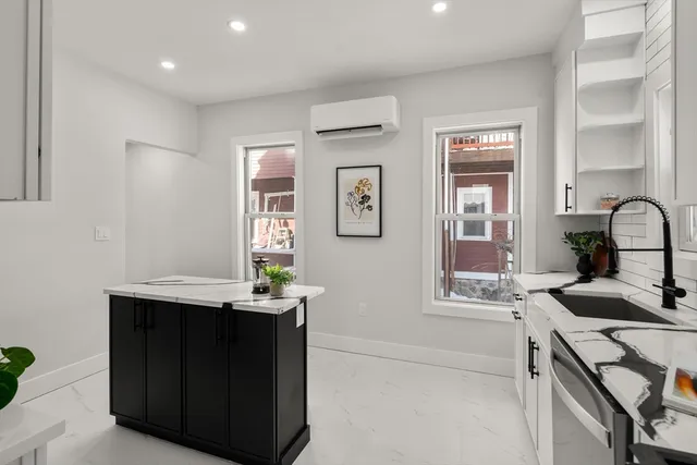 a kitchen with a sink cabinets and window