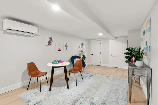 a workspace room with furniture and a potted plant