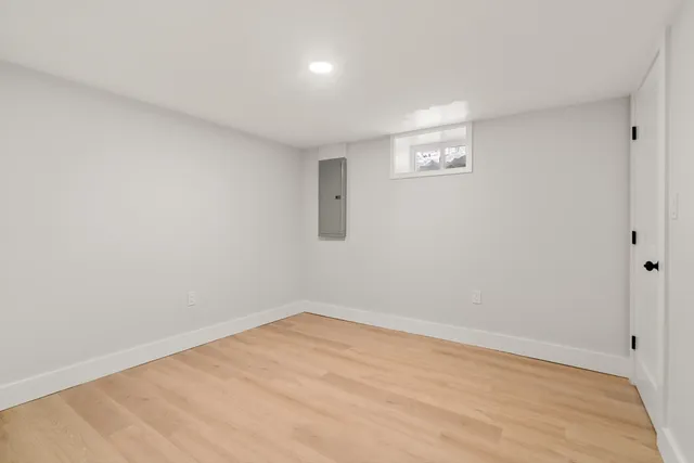 a view of a big room with wooden floor and windows