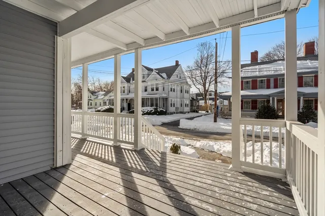 a view of a balcony with wooden floor
