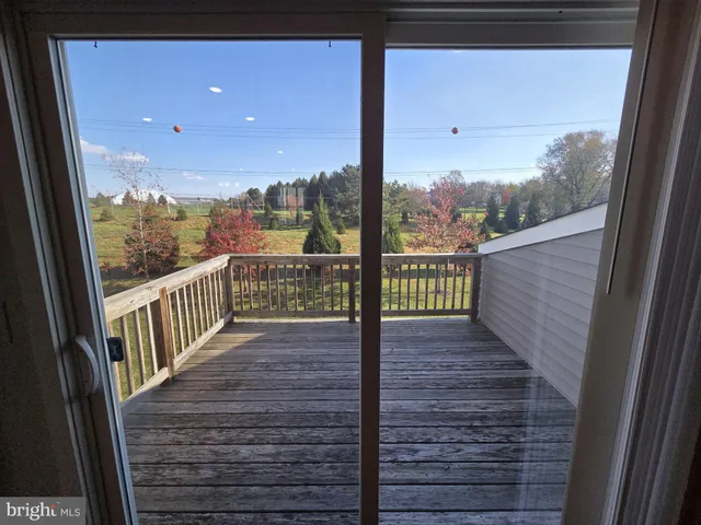 a view of a balcony with wooden floor