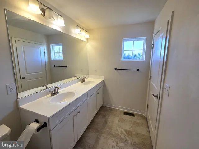 a bathroom with a sink a mirror and a shower