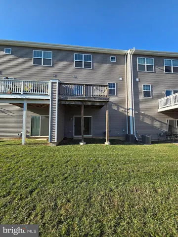 front view of a brick house with a yard