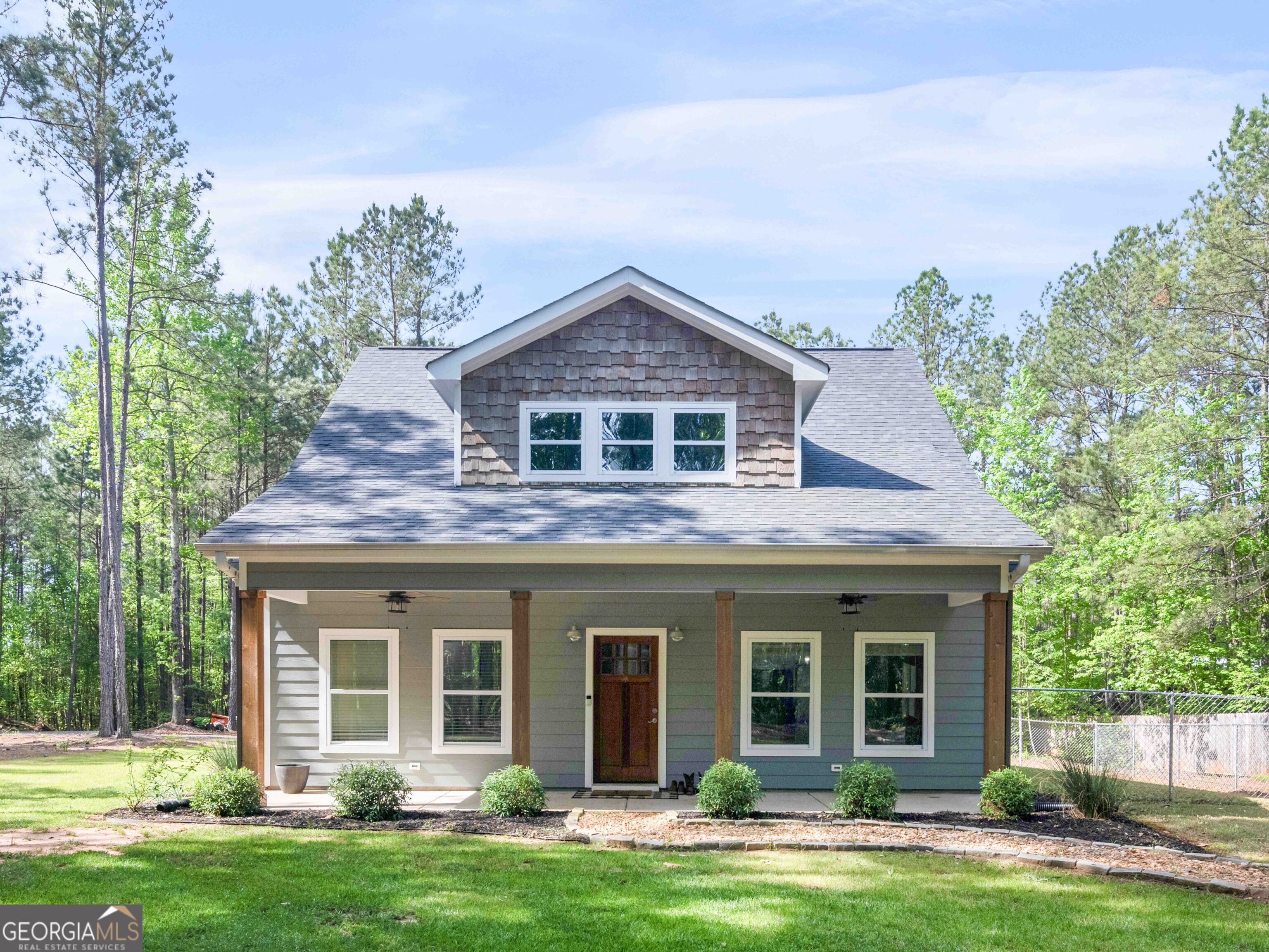 a front view of a house with garden