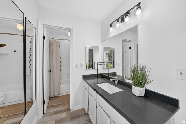788 East Gables Street Midvale, UT 84047 - Photo 12 of 24 Bathroom featuring a single vanity with a dark countertop, an integrated rectangular sink, and a large wall-mounted mirror