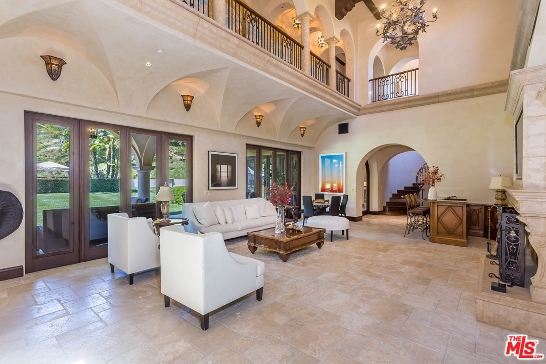 44 Beverly Park Circle Beverly Hills, CA 90210 - Photo 11 of 52 a living room with furniture gym equipment and a large window