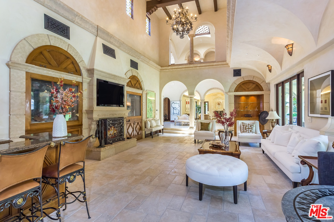 44 Beverly Park Circle Beverly Hills, CA 90210 - Photo 12 of 52 a living room with fireplace furniture and a flat screen tv