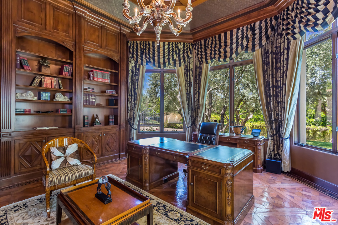 44 Beverly Park Circle Beverly Hills, CA 90210 - Photo 21 of 52 a living room with furniture and a bookshelf