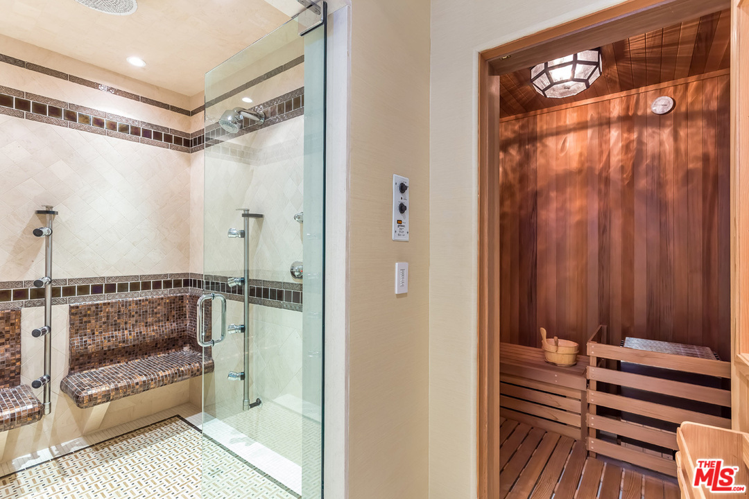 44 Beverly Park Circle Beverly Hills, CA 90210 - Photo 25 of 52 a bathroom with a shower and a sink