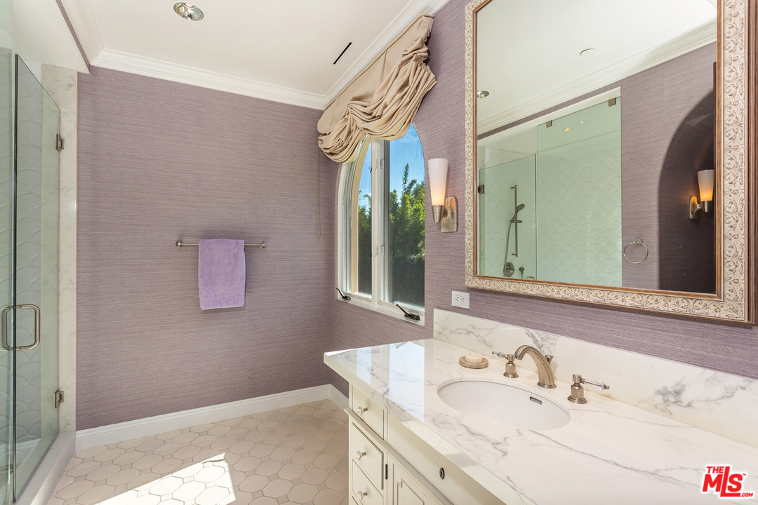 44 Beverly Park Circle Beverly Hills, CA 90210 - Photo 28 of 52 a bathroom with a granite countertop sink and a mirror