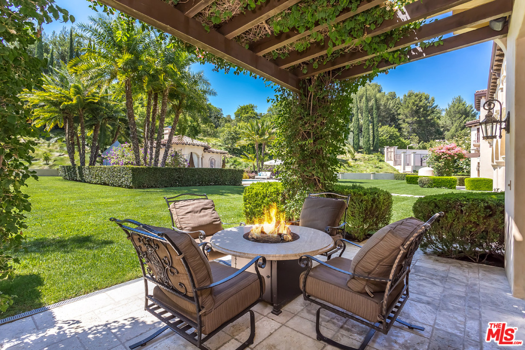 44 Beverly Park Circle Beverly Hills, CA 90210 - Photo 37 of 52 a view of a chairs and table in patio with a small yard