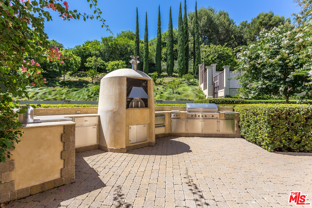 44 Beverly Park Circle Beverly Hills, CA 90210 - Photo 46 of 52 a view of a chairs and table on the terrace