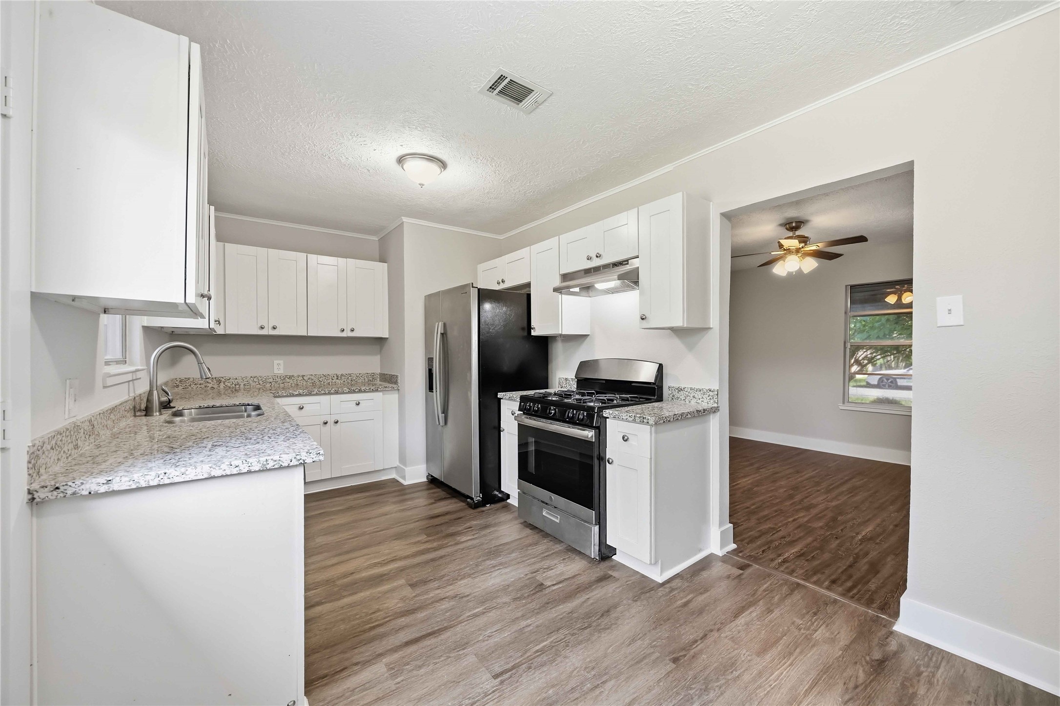 113 East Witcher Lane Houston, TX 77076 - Photo 11 of 21 a kitchen with granite countertop a refrigerator stove and sink