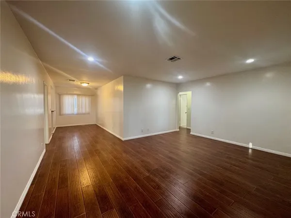 a view of room with wooden floor and staircase