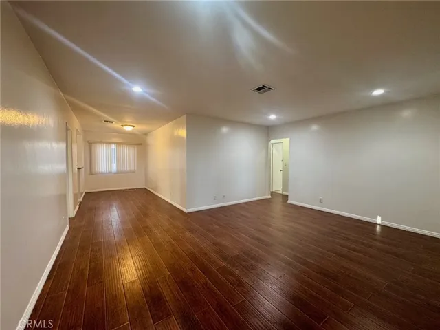 a view of room with wooden floor and staircase