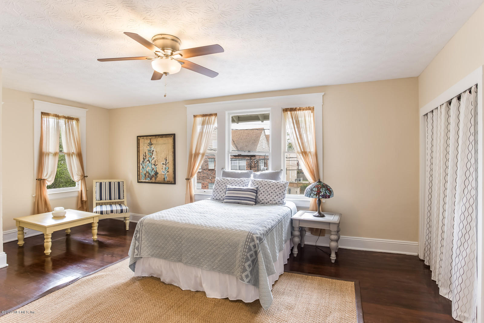 1620 Cherry Street Jacksonville, FL 32205 - Photo 29 of 34 a bedroom with a bed and a chandelier