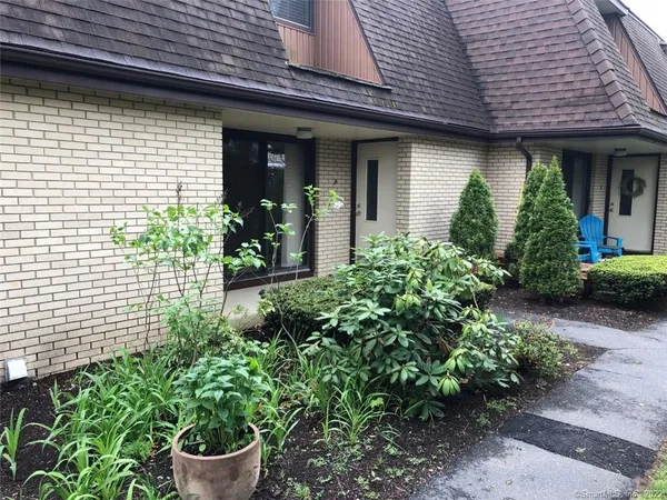 a view of a house with potted plants