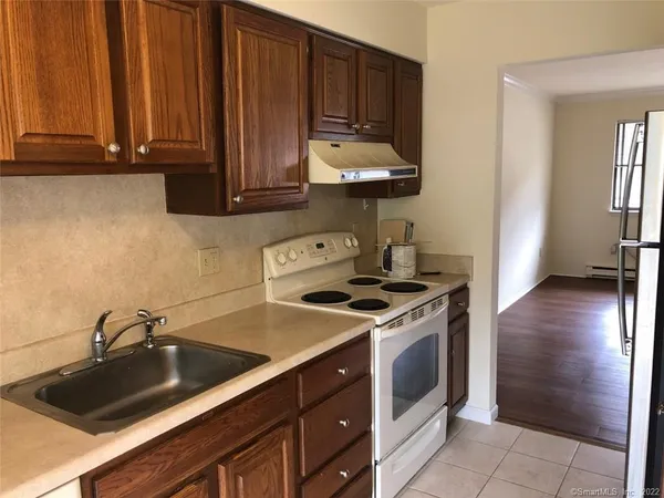 a kitchen with a sink stove and cabinets
