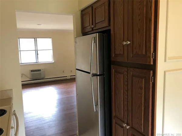 a view of a refrigerator in kitchen and wooden floor