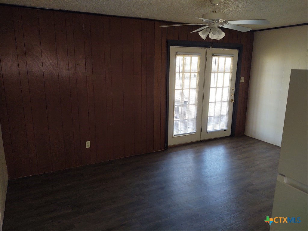 200-220 Quail Run Road Martindale, TX 78655 - Photo 11 of 16 an empty room with wooden floor and windows